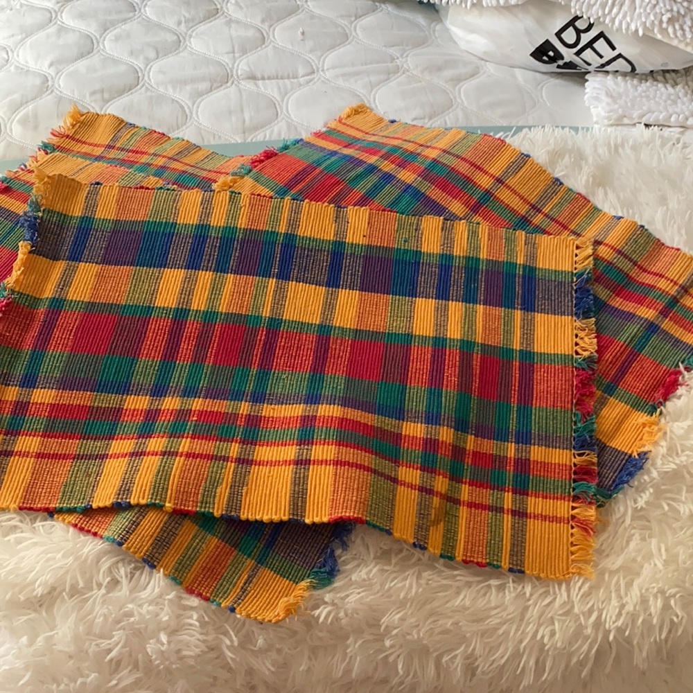 Four cloth placemats.
